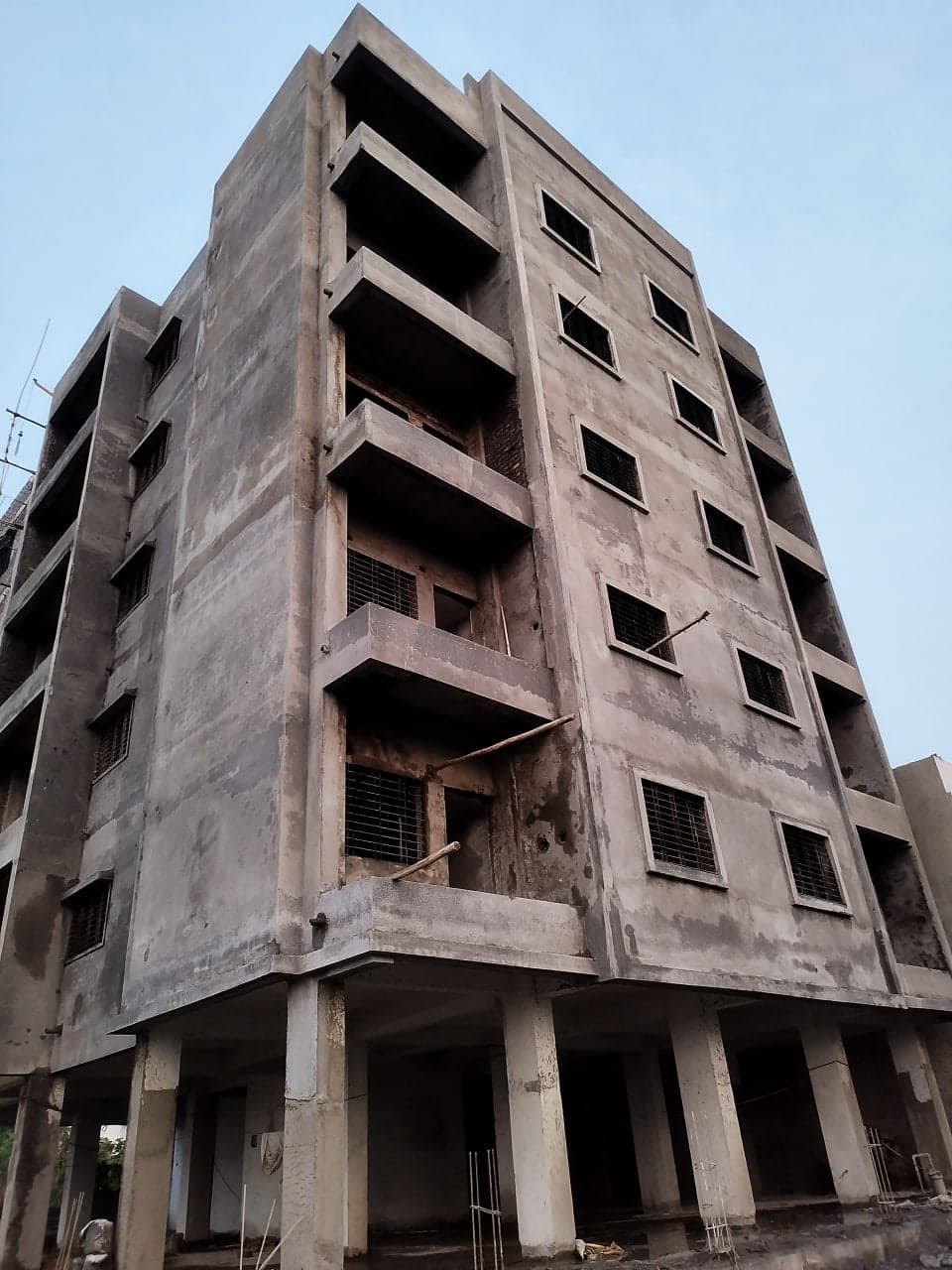 Corner view of the building showing stilt parking level
